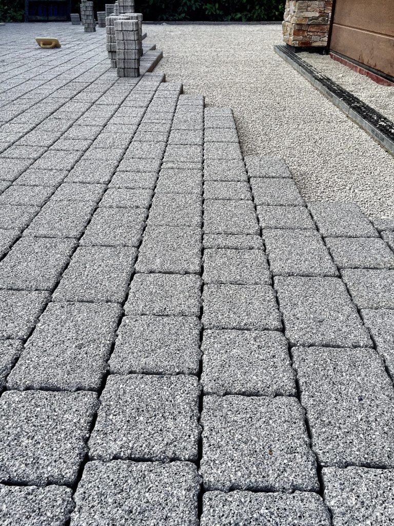 Paving blocks being laid on a driveway.